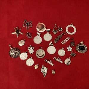 Various silver tone pendants and charms